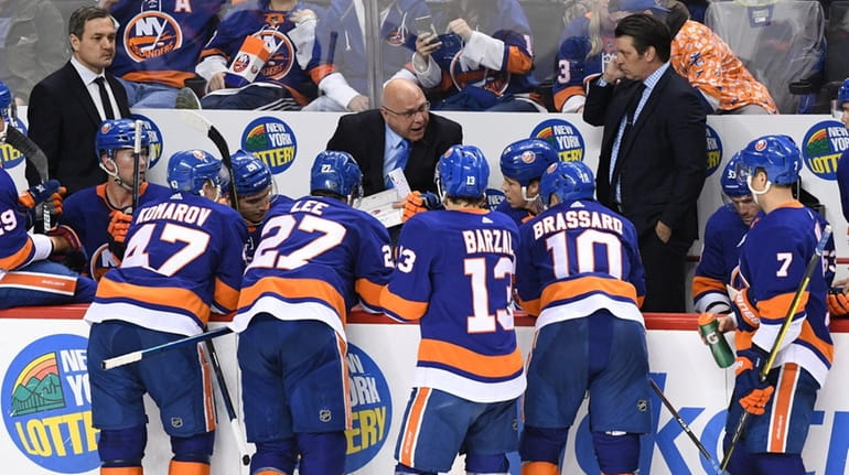 Islanders head coach Barry Trotz directs his players during a...