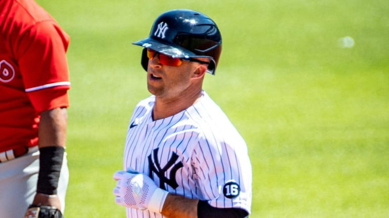 Yankees' Brett Gardner rounds the bases after hitting a grand...