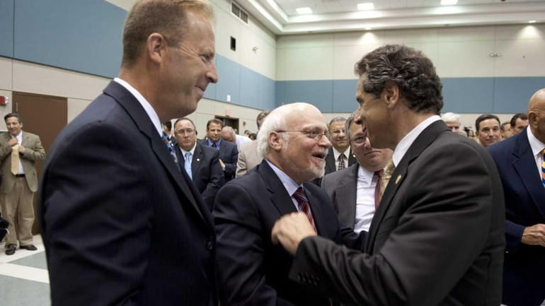Gov. Andrew M. Cuomo shakes hands with Hofstra president Stuart...