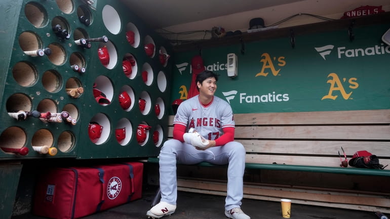 Los Angeles Angels' Shohei Ohtani sits in the dugout before...