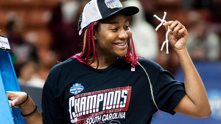 South Carolina's Aliyah Boston holds up her piece of the...