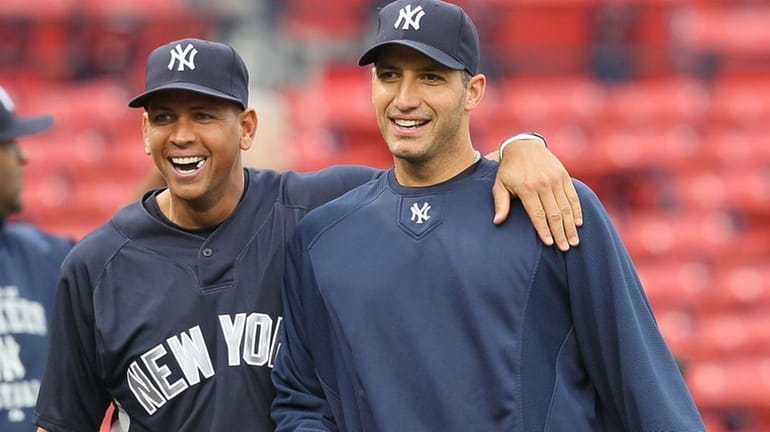 Andy Pettitte #46 and Alex Rodriguez #13 of the New...
