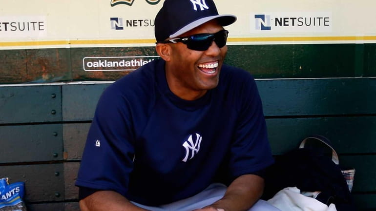 Mariano Rivera of the Yankees smiles in the dugout before...