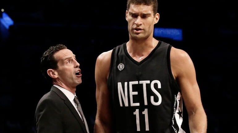 Brooklyn Nets' head coach Kenny Atkinson speaks to his center...