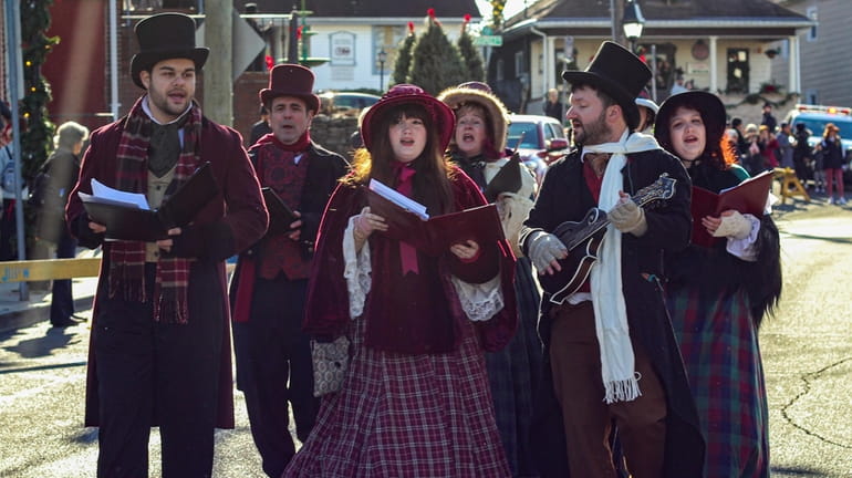 Christmas carolers will perform in the streets at the 26th...