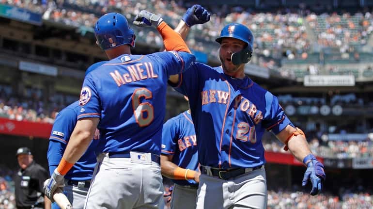 Pete Alonso, right, meets Jeff McNeil after hitting a three-run...