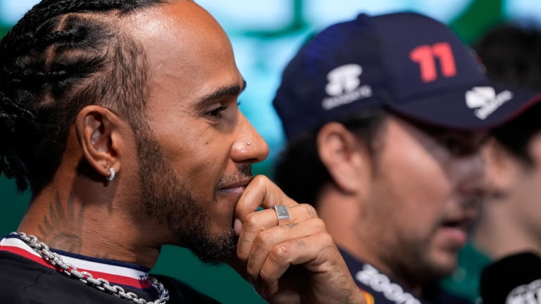 Mercedes driver Lewis Hamilton of Britain speaks to media ahead...