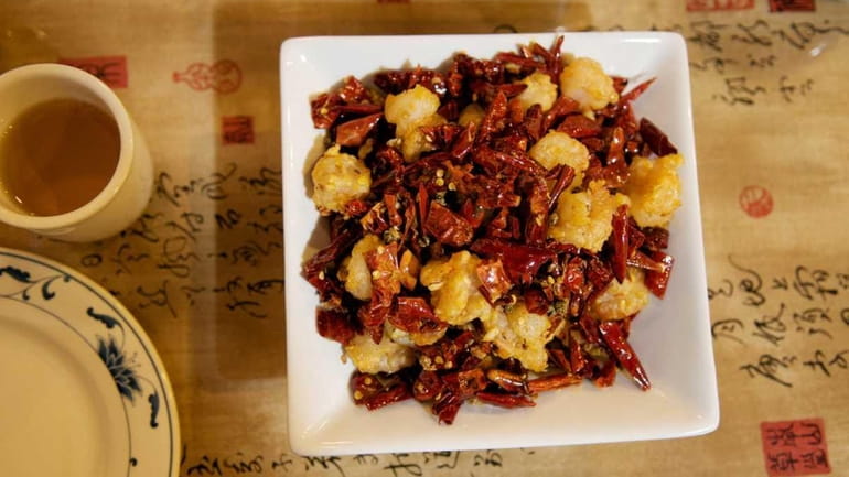 Deep fried shrimp with chili and pepper is offered at...