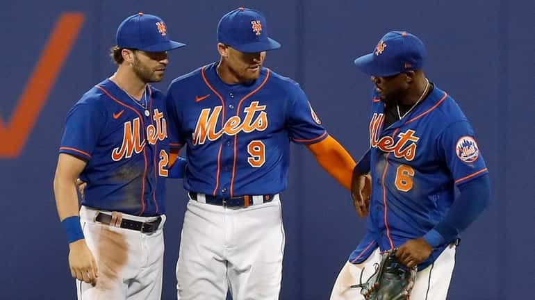 Tyler Naquin, Brandon Nimmo and Starling Marte of the Mets celebrate after defeating...