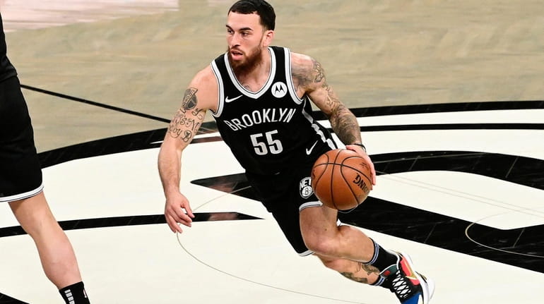 Mike James of the Brooklyn Nets handles the ball against...