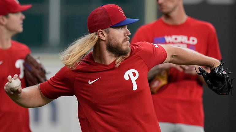 The Phillies' Noah Syndergaard warms up during batting practice before...