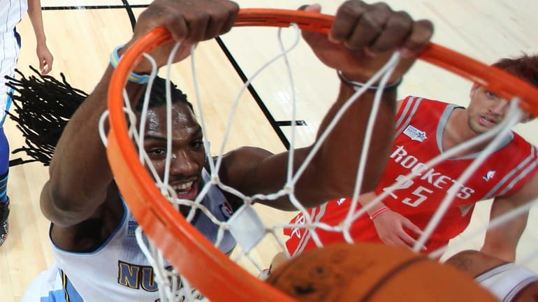 Team Chuck's Kenneth Faried, of the Denver Nuggets, dunks as...