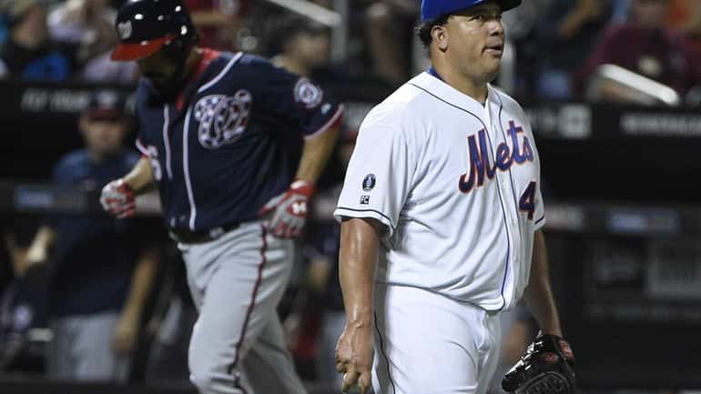 Mets starting pitcher Bartolo Colon looks on as Washington Nationals...