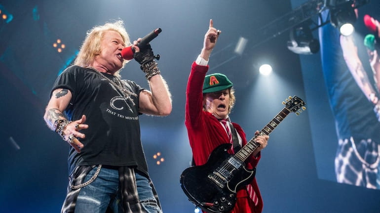 Axl Rose, left, and Angus Young of AC/DC perform at...