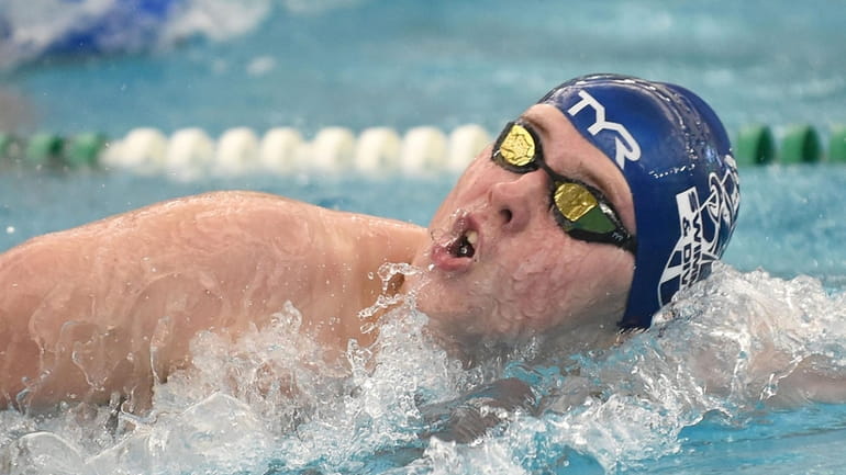 Dylan Gallub of Hauppauge-Smithtown competes in the 100-yard freestyle event...