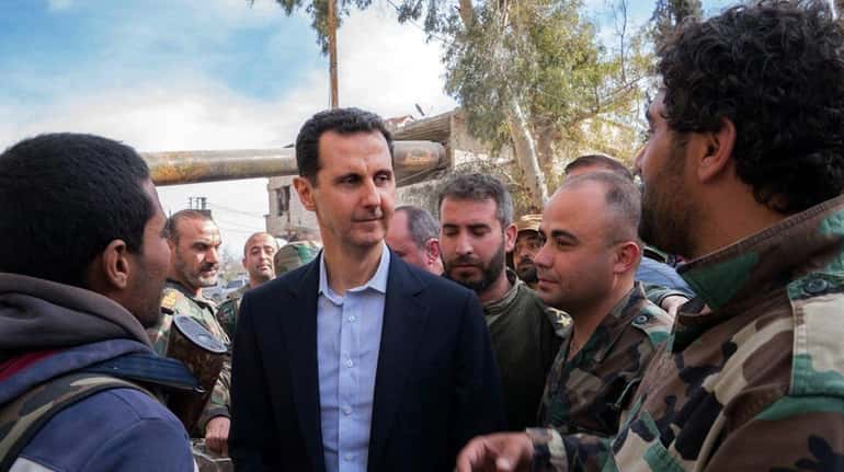 Syrian President Bashar Assad with government troops in Eastern Ghouta...