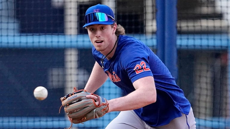 The Mets' Brett Baty fields a ball during practice prior...
