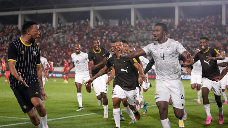 South Africa's Teboho Mokoena, right, celebrates with teammates after scoring...
