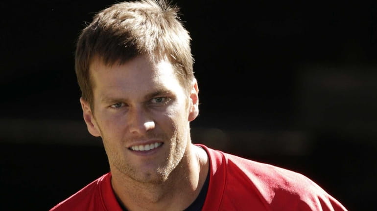 New England Patriots quarterback Tom Brady heads to the field...