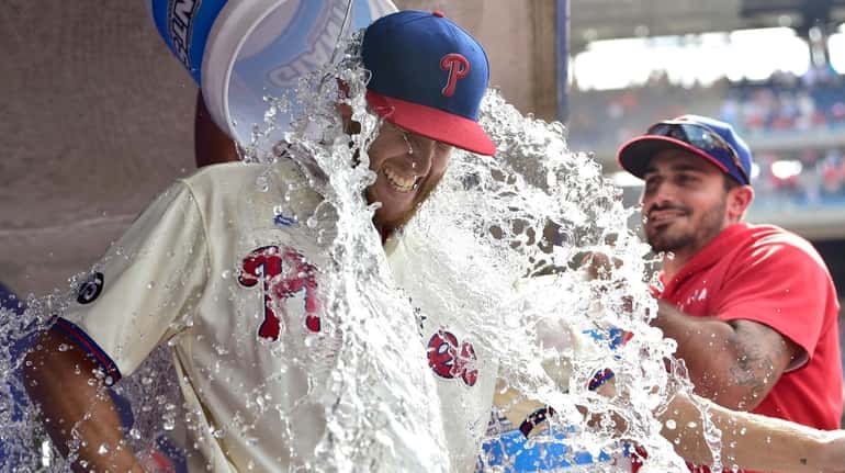 Philadelphia Phillies starting pitcher Zack Wheeler is doused with water...