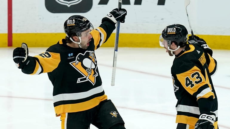 Pittsburgh Penguins' Emil Bemstrom, left, celebrates with Jansen Harkins (43)...