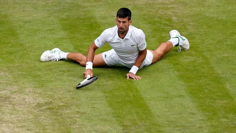 Serbia's Novak Djokovic reacts after making a passing shot to...