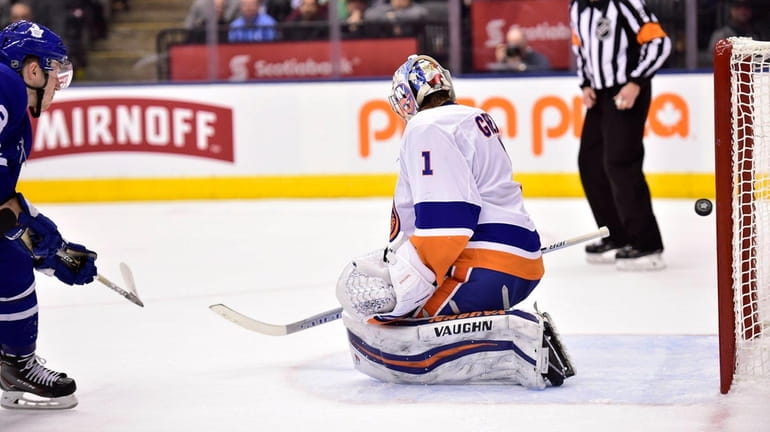 Maple Leafs defenseman Travis Dermott scores past Islanders goaltender Thomas...