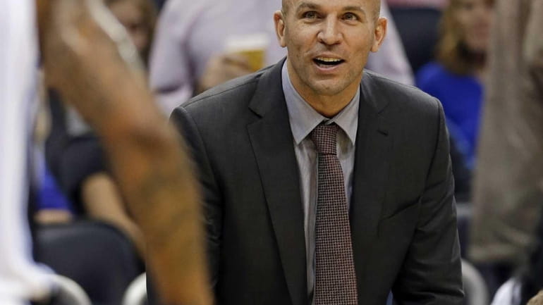 Jason Kidd watches his team during the first half of...