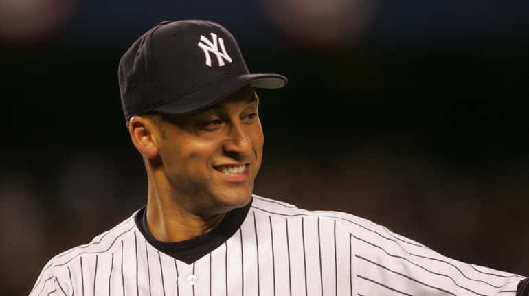 Derek Jeter smiles after making a nice play to end...
