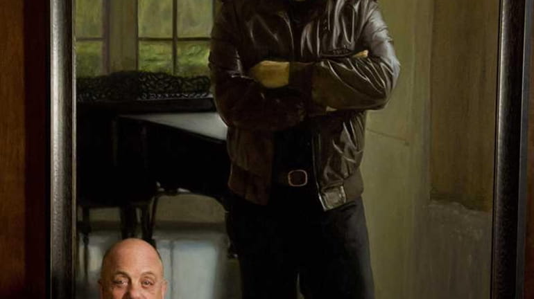 Billy Joel poses next to his portrait at the unveiling...