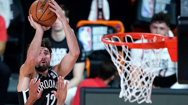 The Nets' Joe Harris shoots against the Trail Blazers during...