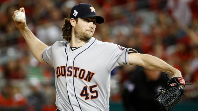 Astros starting pitcher Gerrit Cole throws against the Nationals during...