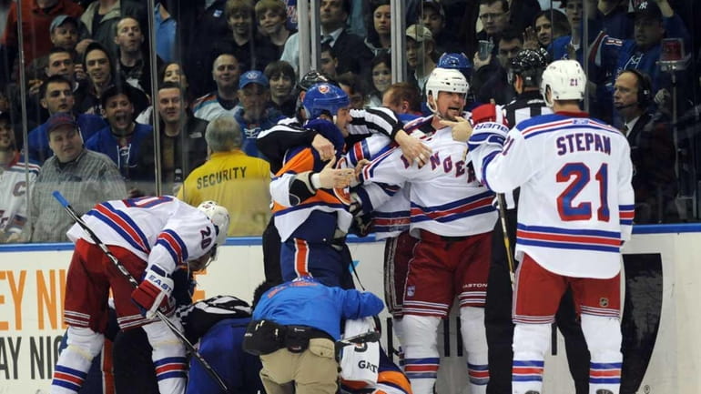 The New York Rangers and New York Islanders scuffle, resulting...