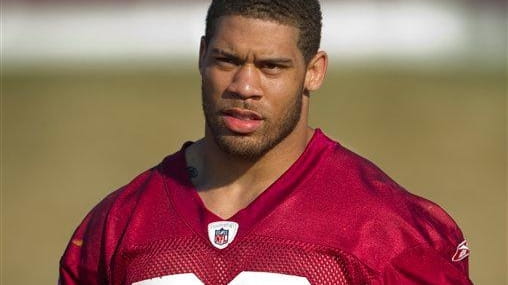LaRon Landry walks to the Redskins practice field before the...