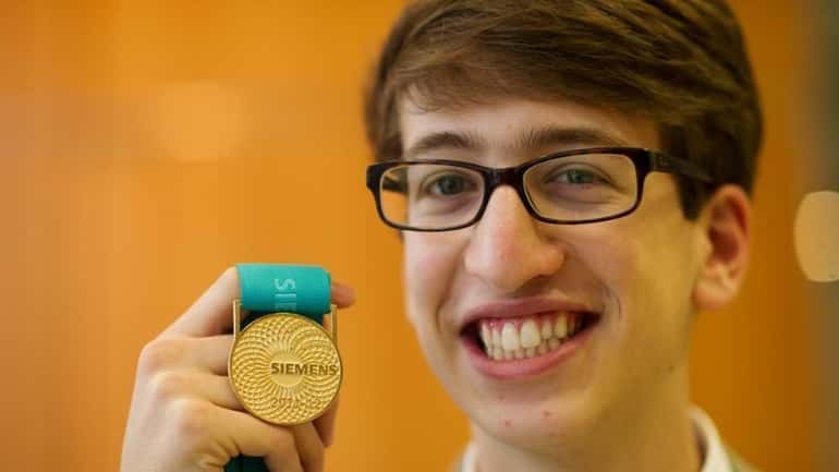 Blake Smith of Oceanside High School holds his medal after...