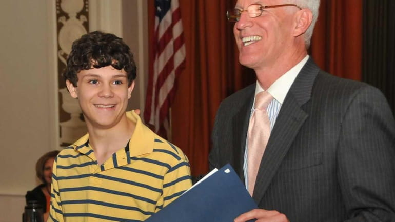 Cory Wohlenberg, 14, with Superintendent Ed Ehmann, was given a...