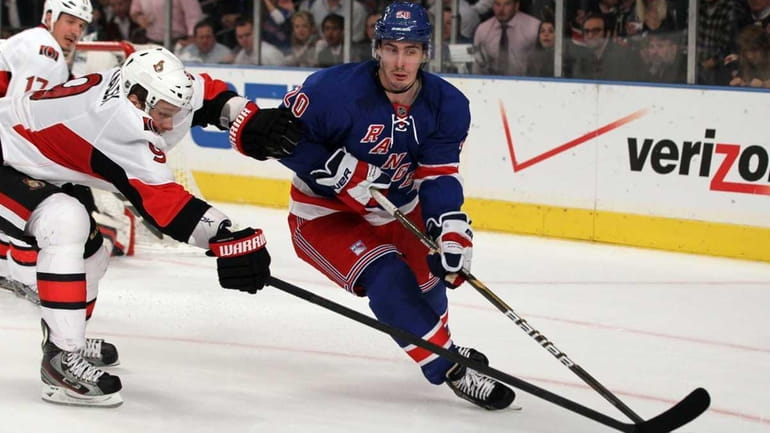 Chris Kreider #20 of the New York Rangers skates against...