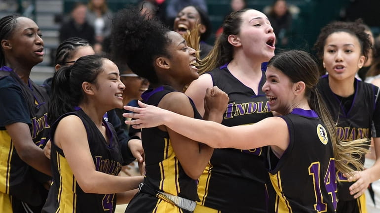 Flo Hunte of Sewanhaka, center, and teammates celebrate after their 62-52...