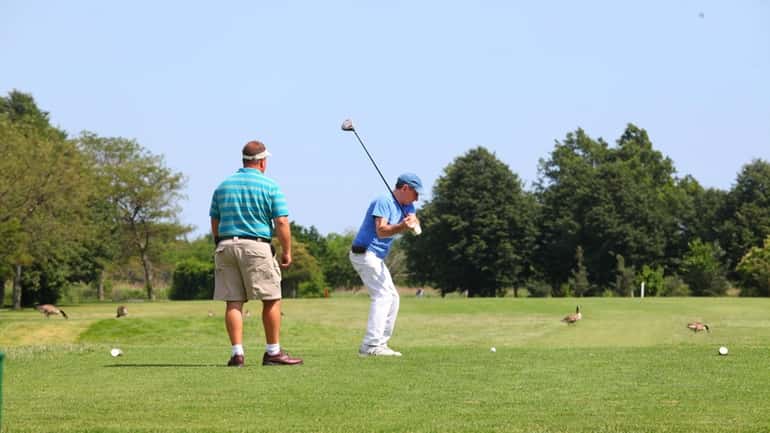 Teeing off at the 9-hold North Woodmere Golf Club run...