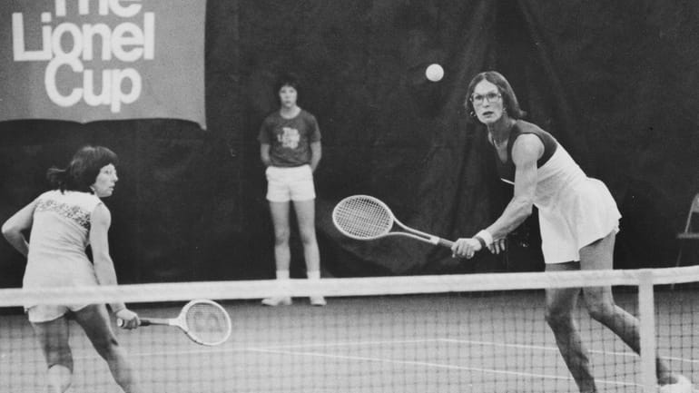 Billie Jean King chases the ball for a backhand as...
