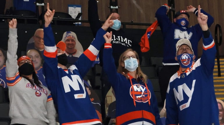 Islanders fans celebrate a second-period goal by Josh Bailey against the...