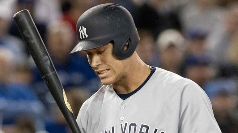 Yankees outfielder Aaron Judge reacts after striking out in during...
