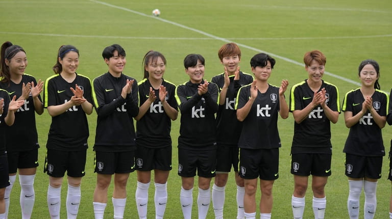 South Korea's forward Ji So-yun (C) and her teammates attend...