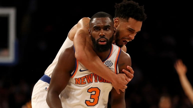 Tim Hardaway Jr. #3 of the Knicks is congratulated by...