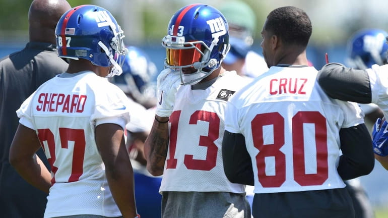 New York Giants wide receiver Odell Beckham, facing, talks with...