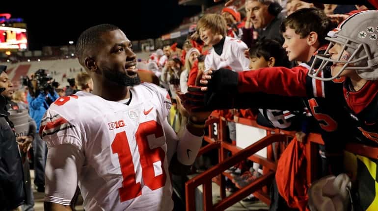 Ohio State quarterback J.T. Barrett greets fans after a game...