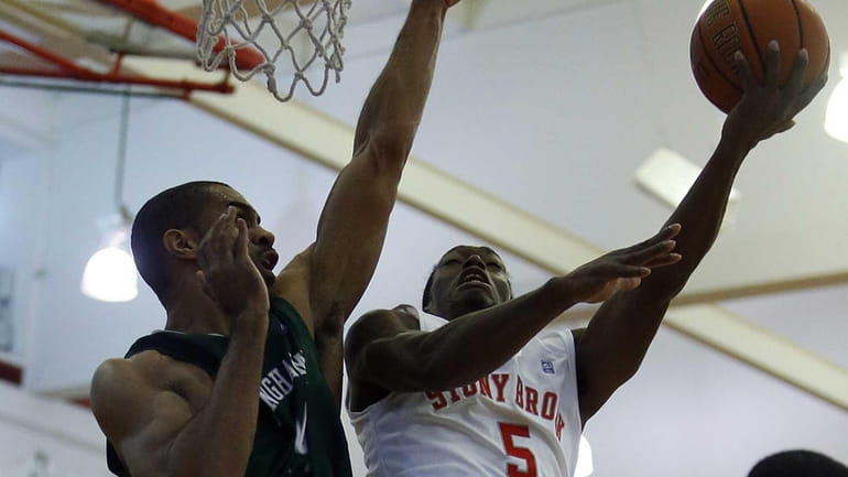 Dave Coley (5) goes up for the layup against Binghamton's...
