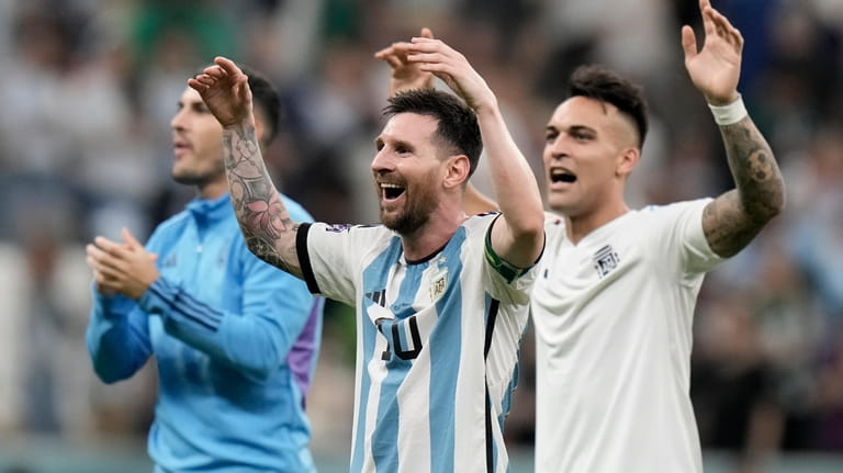 Argentina's Lionel Messi, center, celebrates at the end of the...