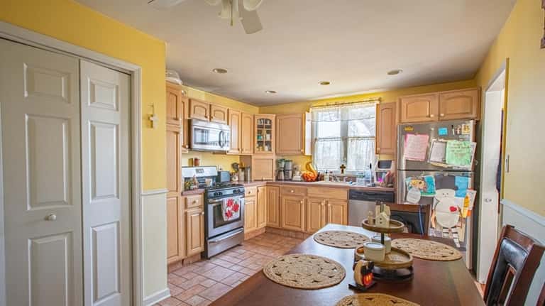 The kitchen has stainless steel appliances and Formica counters.