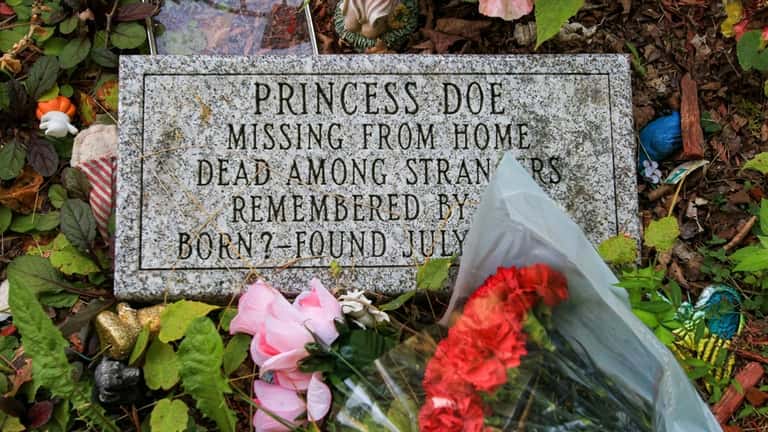 Fresh flowers and mementos decorate the gravesite of "Princess Doe"...